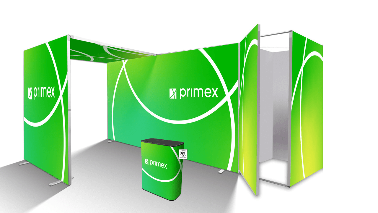 Messestand bestehend aus mehreren grünen Messewänden mit primex-Logo, einer ovalen Messetheke im Vordergrund sowie einer integrierten Messekabine.